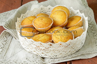 homemade vanilla muffins in a basket of lace napkins
