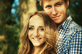 Young couple in nature on summer, looking into the camera