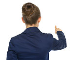 Business woman pointing. rear view
