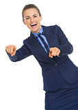 Smiling business woman pointing in camera