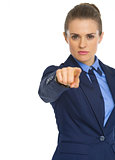 Serious business woman pointing in camera
