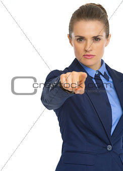 Serious business woman pointing in camera