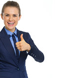 Smiling business woman showing thumbs up