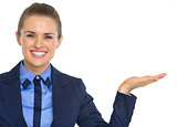 Smiling business woman presenting something on empty palm