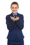 Happy business woman presenting something on empty palm