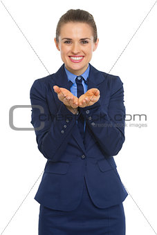 Happy business woman presenting something on empty palm