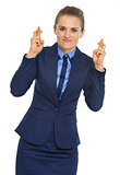 Portrait of business woman with crossed fingers