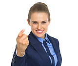 Portrait of happy business woman beckoning with finger