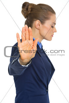 Serious business woman showing stop gesture