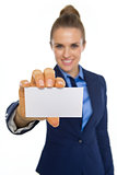Closeup on happy business woman showing business card