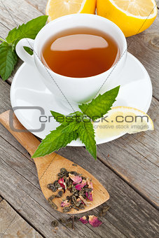 Green tea with lemon and mint on wooden table