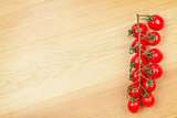 Cherry tomatoes on wooden table background