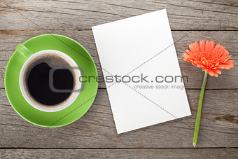 Coffee cup, blank paper and gerbera flower
