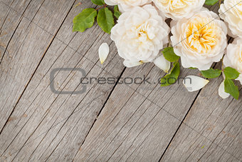 Wooden background with fresh rose flowers