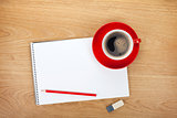 Blank notepad with office supplies and red coffee cup
