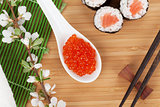 Red caviar, sushi set, sakura branch and chopsticks