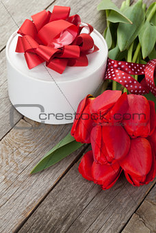 Fresh red tulips with gift box