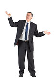 Mature businessman standing with arms out