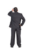Mature businessman standing and scratching head
