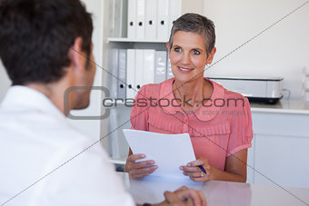 Casual business people having a meeting at desk