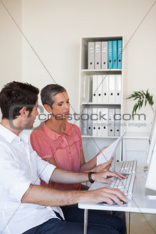 Casual business team working together at desk