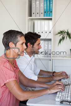 Casual business team working at desk using computers
