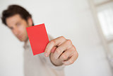 Casual businessman showing red card