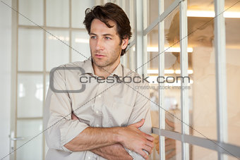 Casual worried businessman leaning on window