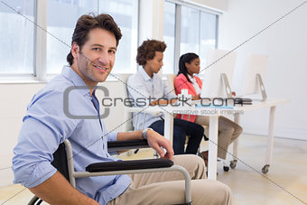 Businessman in wheelchair with disability at work