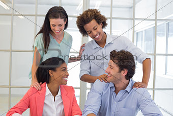 Coworkers congratulating and praising each other