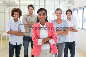 Businesswoman and coworkers smiling at camera