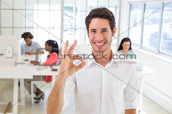 Worker giving an OK gesture