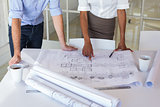 Two architects looking at blueprints