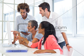 Workers looking at a presentation on the computer