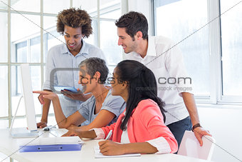 Casual business team having a meeting with computer