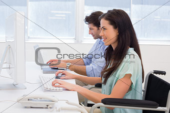 Worker in wheelchair working on computer