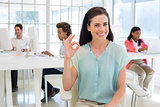 Attractive businesswoman giving OK sign to camera