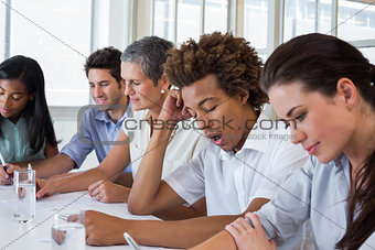 Yawning casual businessman in a meeting
