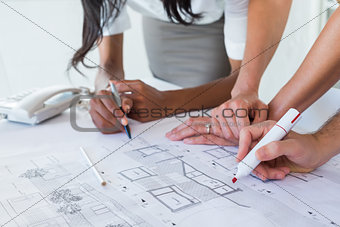 Coworkers working on blueprints together