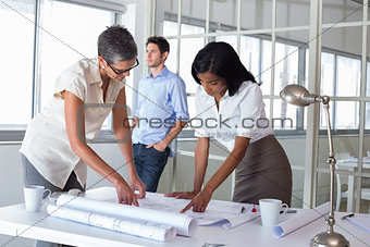 Two architects looking at blueprints