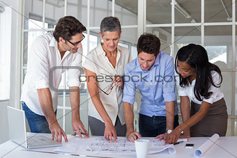 Attractive business people working hard on plans