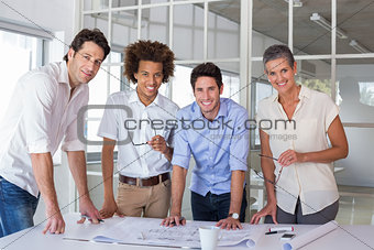 Team of architects smiling at camera