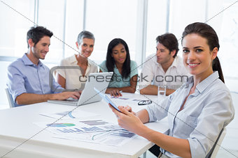 Attractive businesswoman smiling in business meeting
