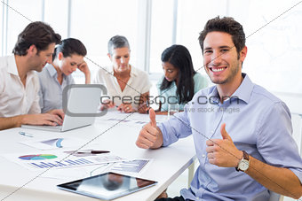 Attractive businessman smiling in the workplace