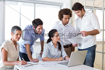 Attractive businessman sharing work in the office
