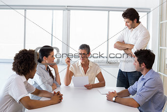 Serious businesswoman speaking to her coworkers