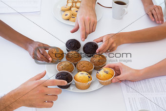 Hungry workers grabbing muffins