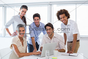 Business people working on laptop smile to camera