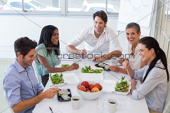 Workers laughing while enjoying lunch break