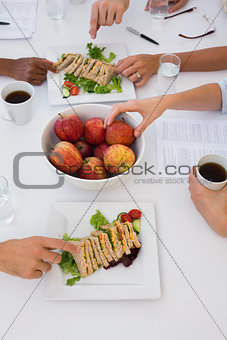 Workers eating healthy lunch during meeting